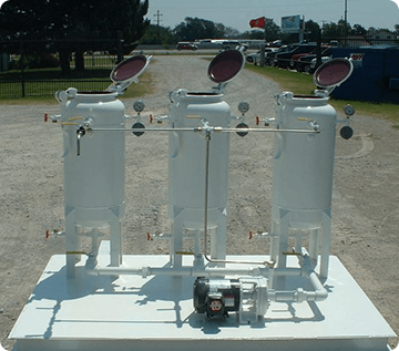 A group of three white tanks sitting on top of a table.